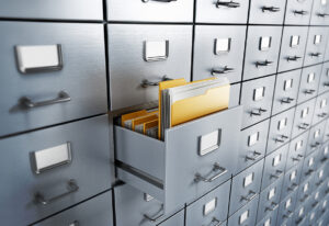 Open filing cabinet drawer filled with folders and documents.