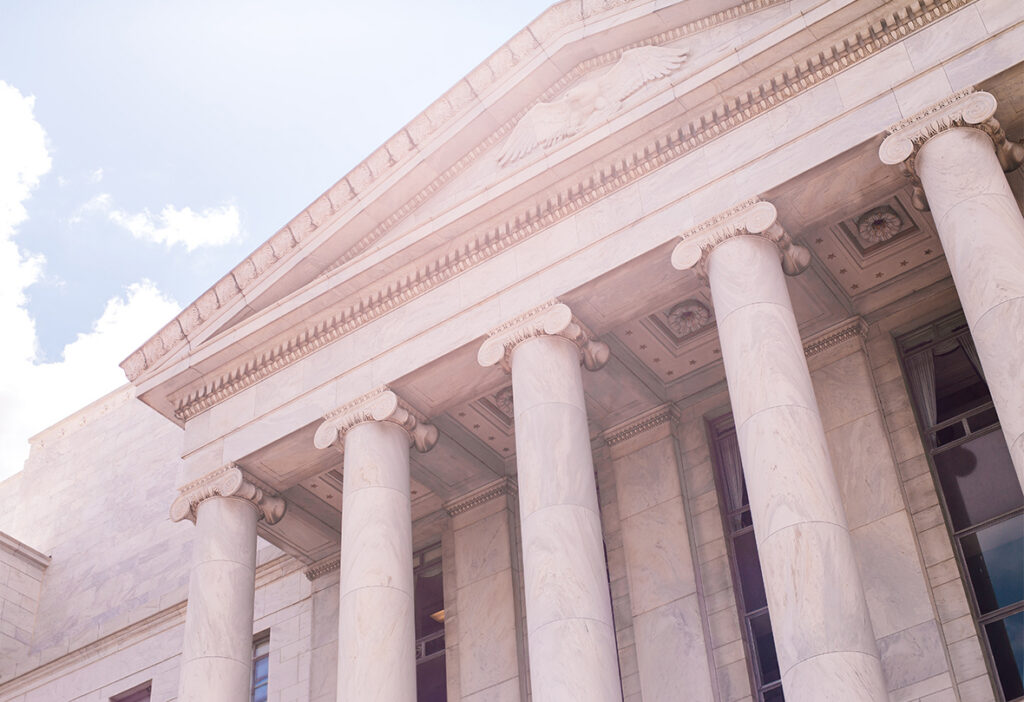 Neoclassical building with large stone columns and decorative architecture.