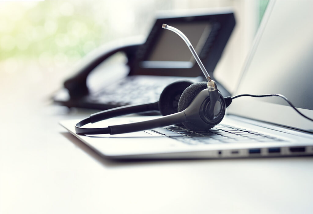 Office headset resting on a laptop computer.
