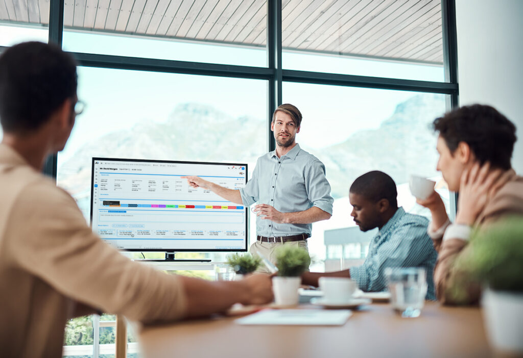 Presenter demonstrating case management software to a team.