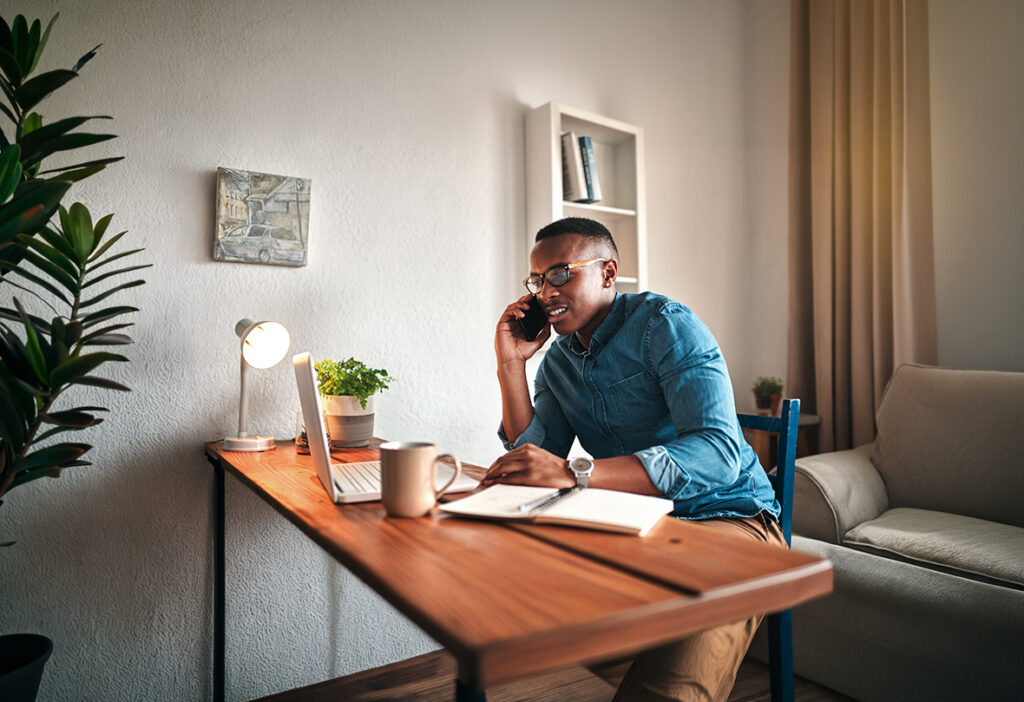 Professional working from home while speaking on the phone.